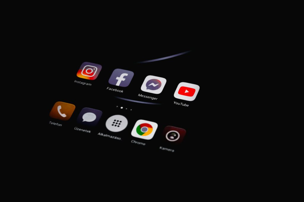 Smartphone screen displaying social media apps representing social media marketing strategies for digital brand growth